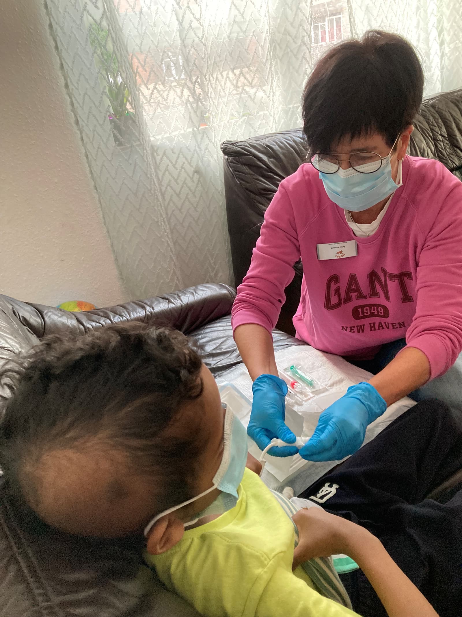 A HOPPS nurse caring for a child at home